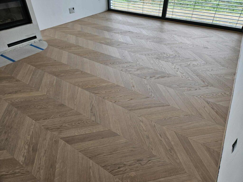 Položen chevron parket z značilnim simetričnim vzorcem v obliki črke V